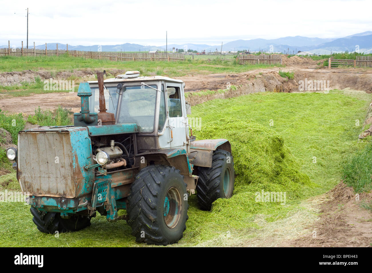 tractor making bunker silo in outdated way Stock Photo