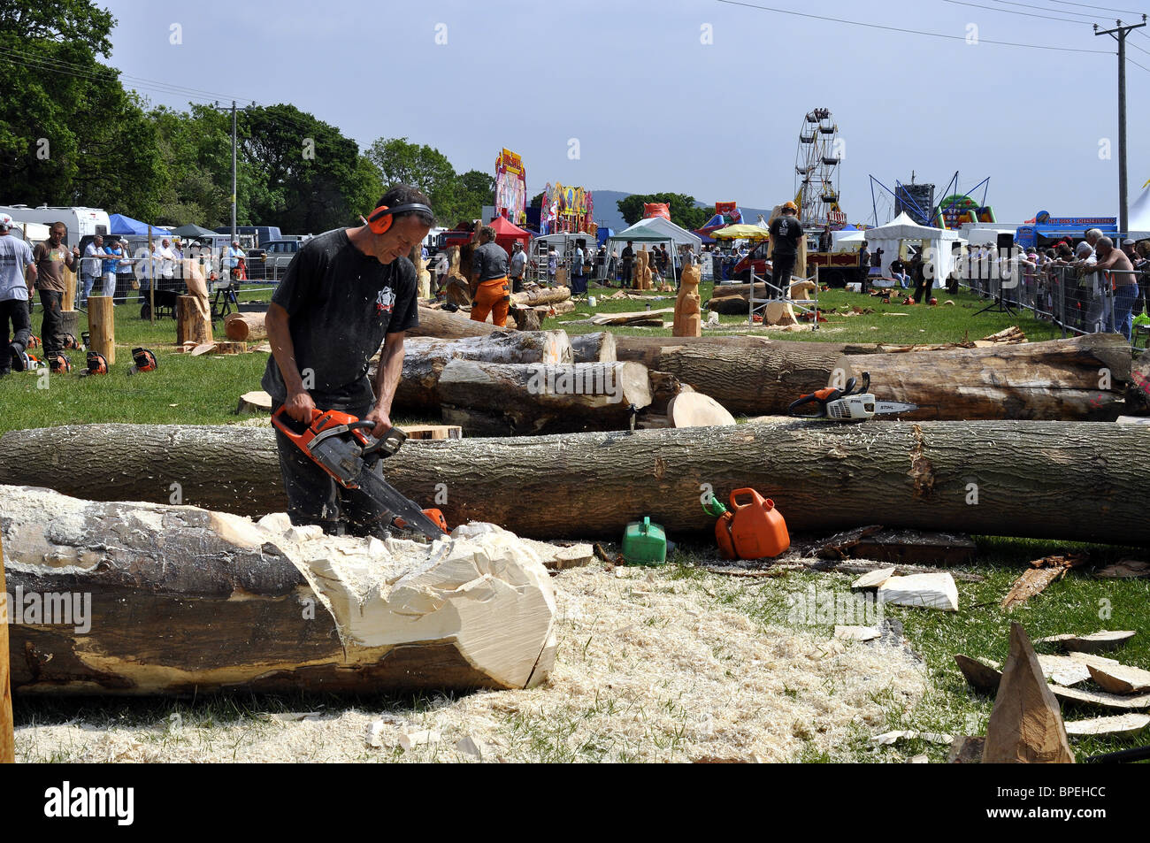 Competitor using a chainsaw  in the Woodfest Wood Carving competition St Asaph North Wales UK Stock Photo