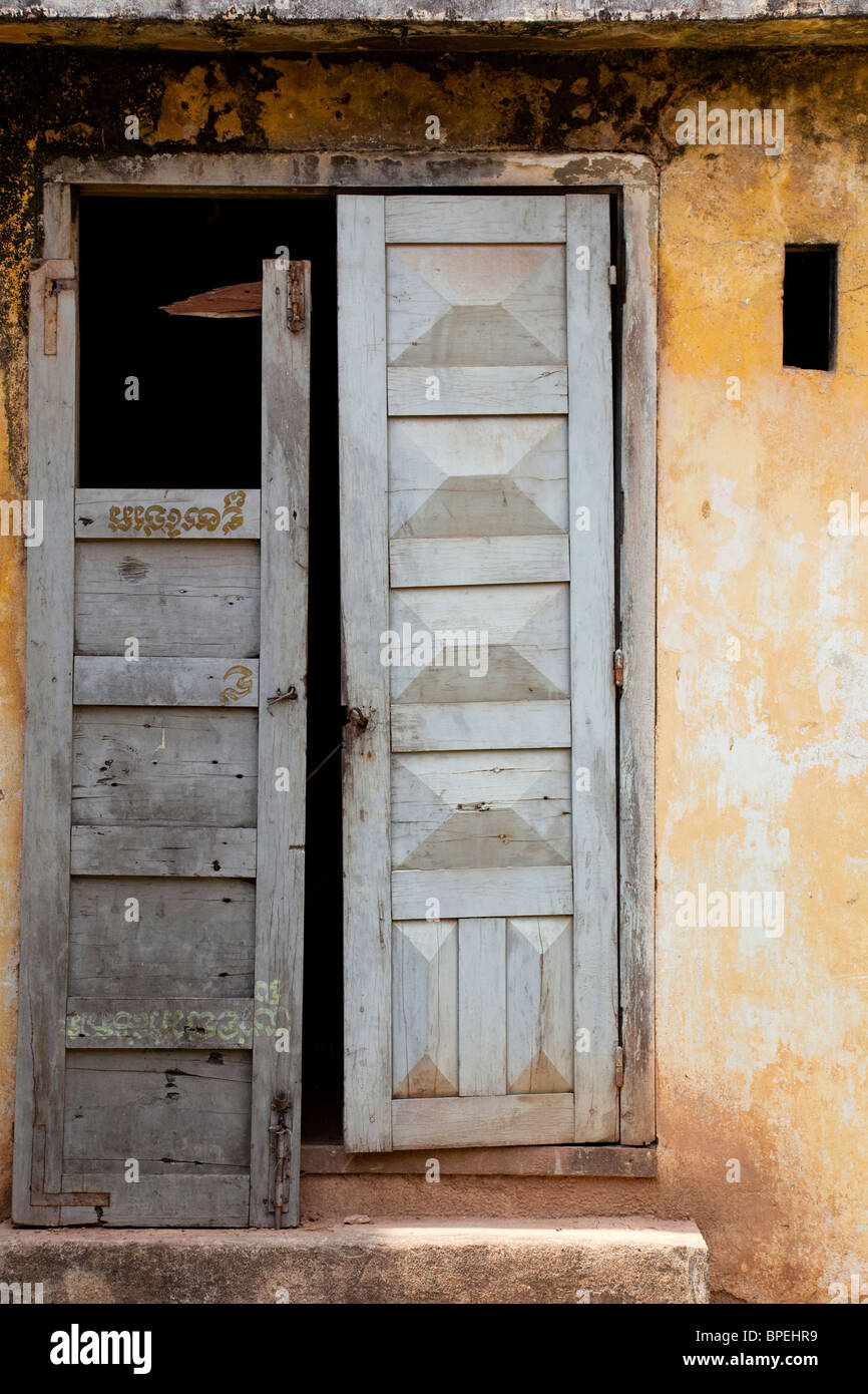 A broken blue wooden-door of a yellow Cambodian building - Kandal Province,  Cambodia Stock Photo - Alamy