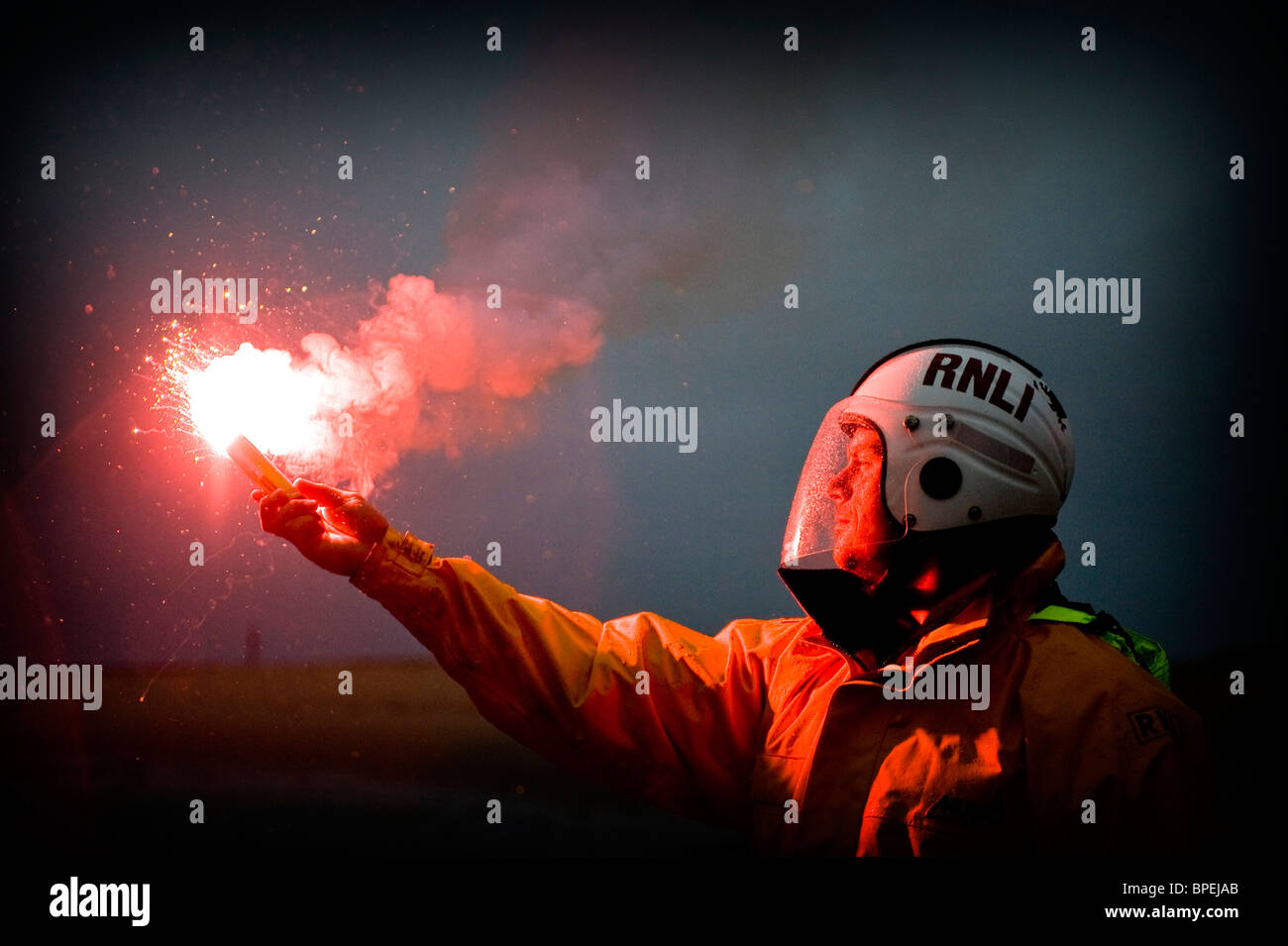 Lifeboat member with flare, Aberdovey, Gwynedd RNLI Aberdovey and Barmouth Lifeboats on Exercise, Gwynedd North Wales UK Stock Photo