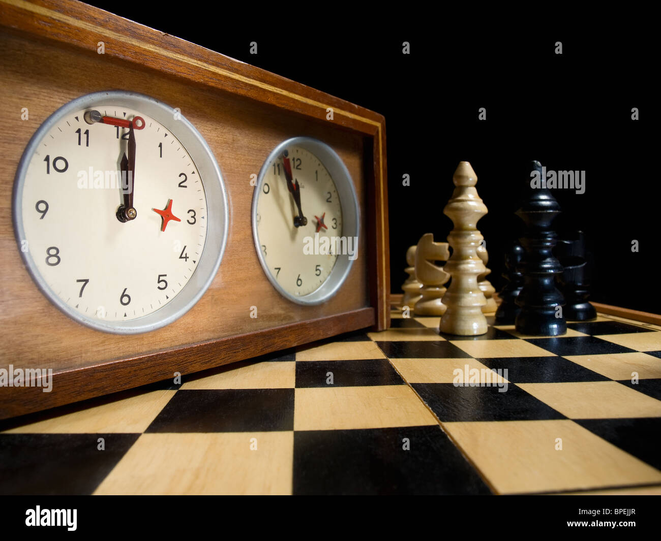 old chess clock on the chessboard with figures ,flag in position which ...