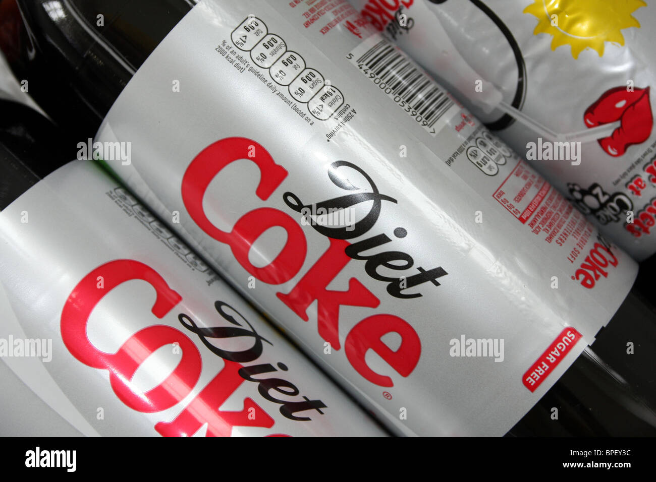 two Diet coke bottles lined up on  a shelf at home Stock Photo