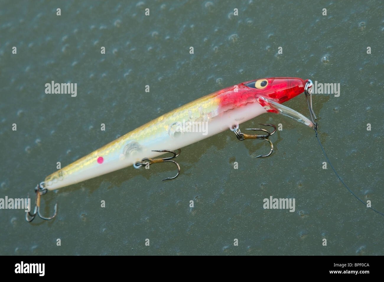 A colourful fishing lure laying on the ice Stock Photo