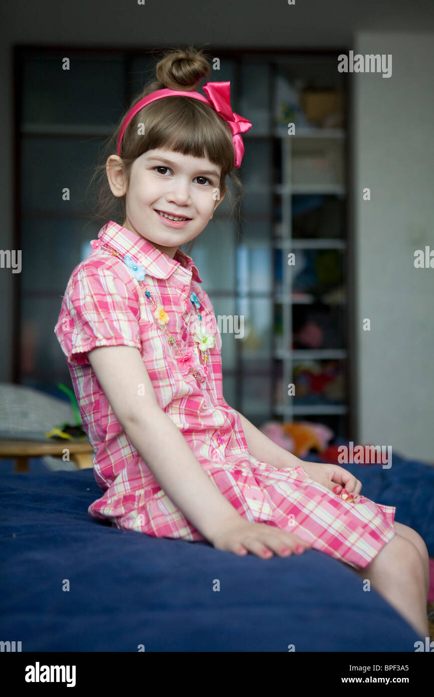little girl sitting on sofa Stock Photo - Alamy
