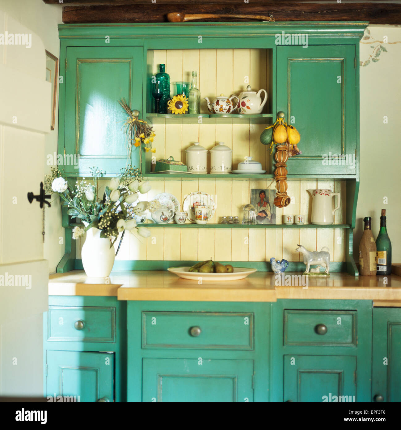 Fitted Turquoise Green Dresser In Cream Kitchen Stock Photo