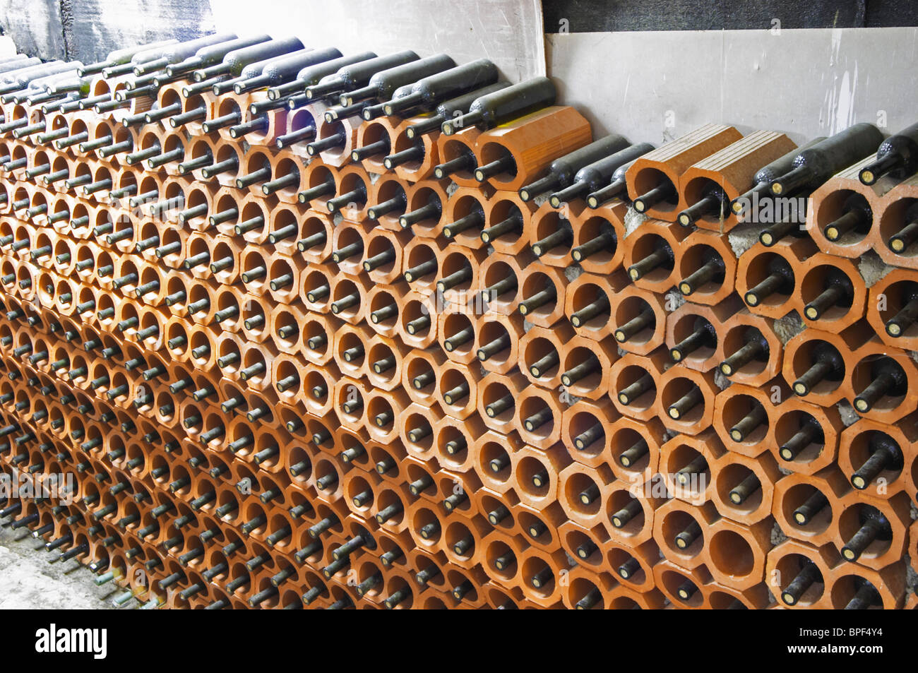 Bottles stored laying down piled high in terracotta earthenware tube
