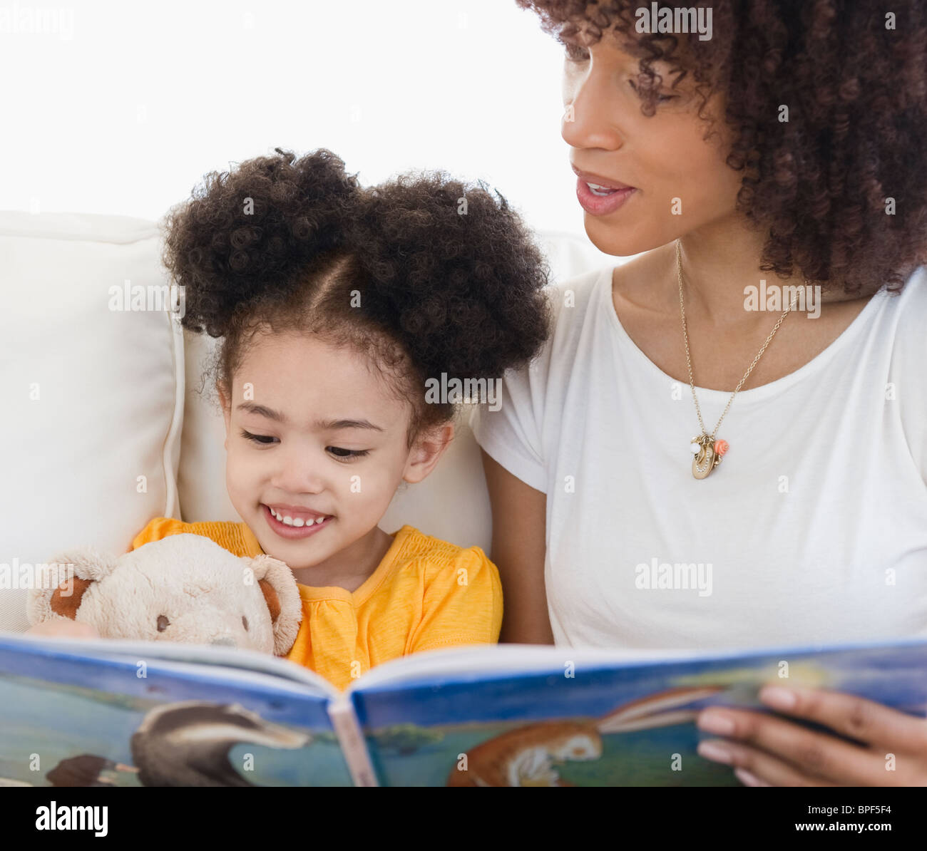 Woman reading book with daughter Stock Photo