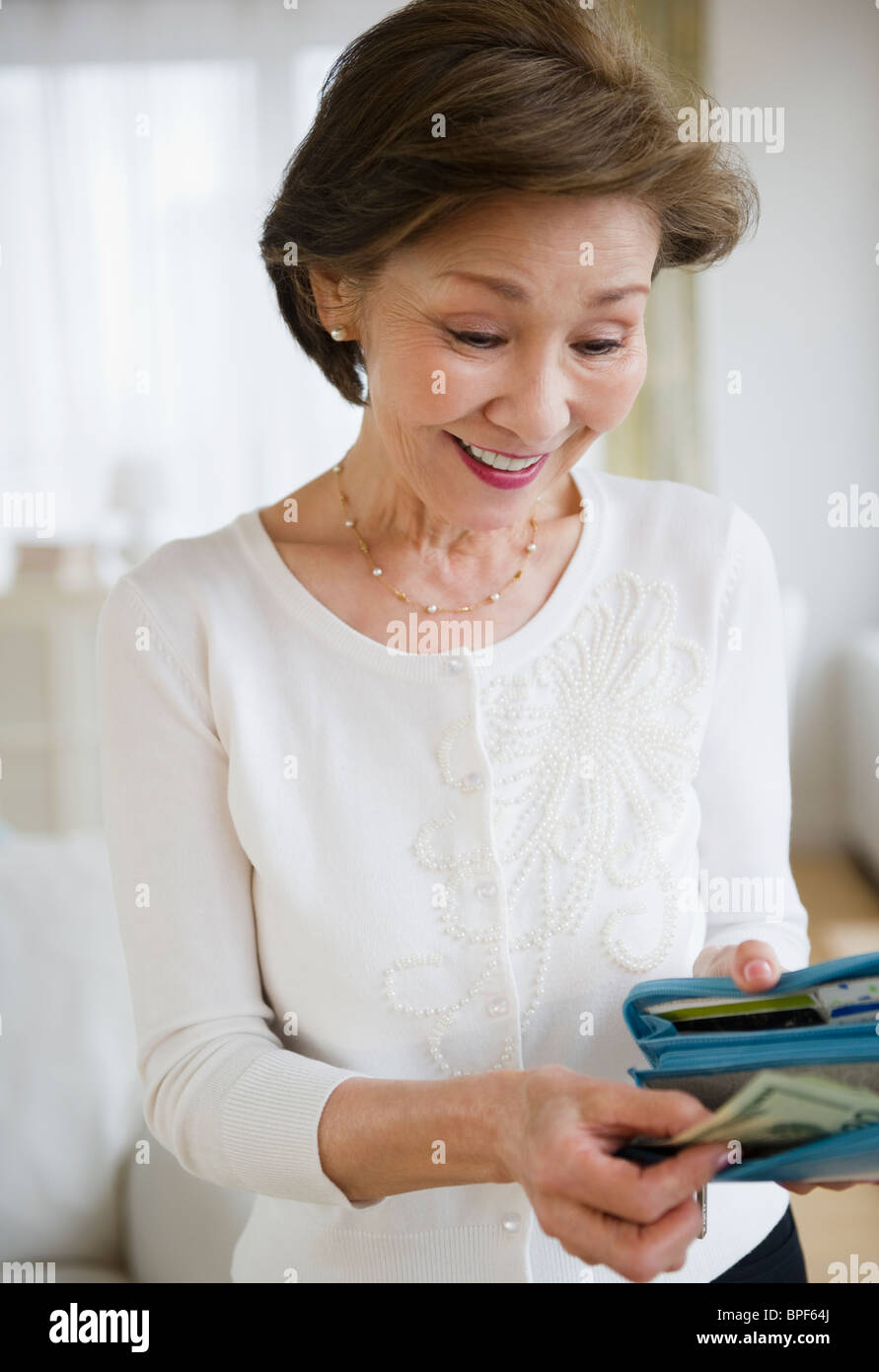 Japanese woman removing money from wallet Stock Photo