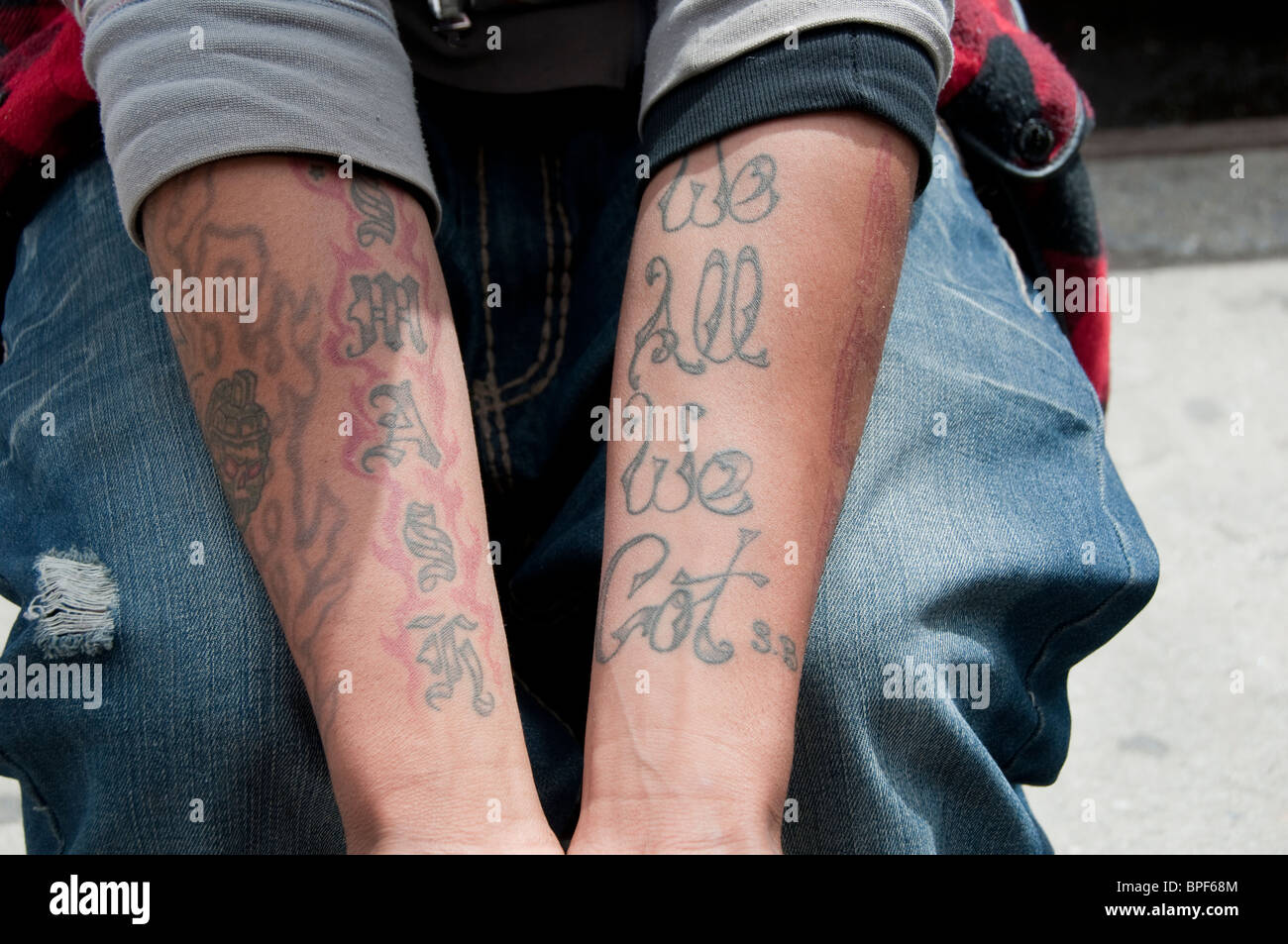 Tattoos on lower arms with words arms Stock Photo