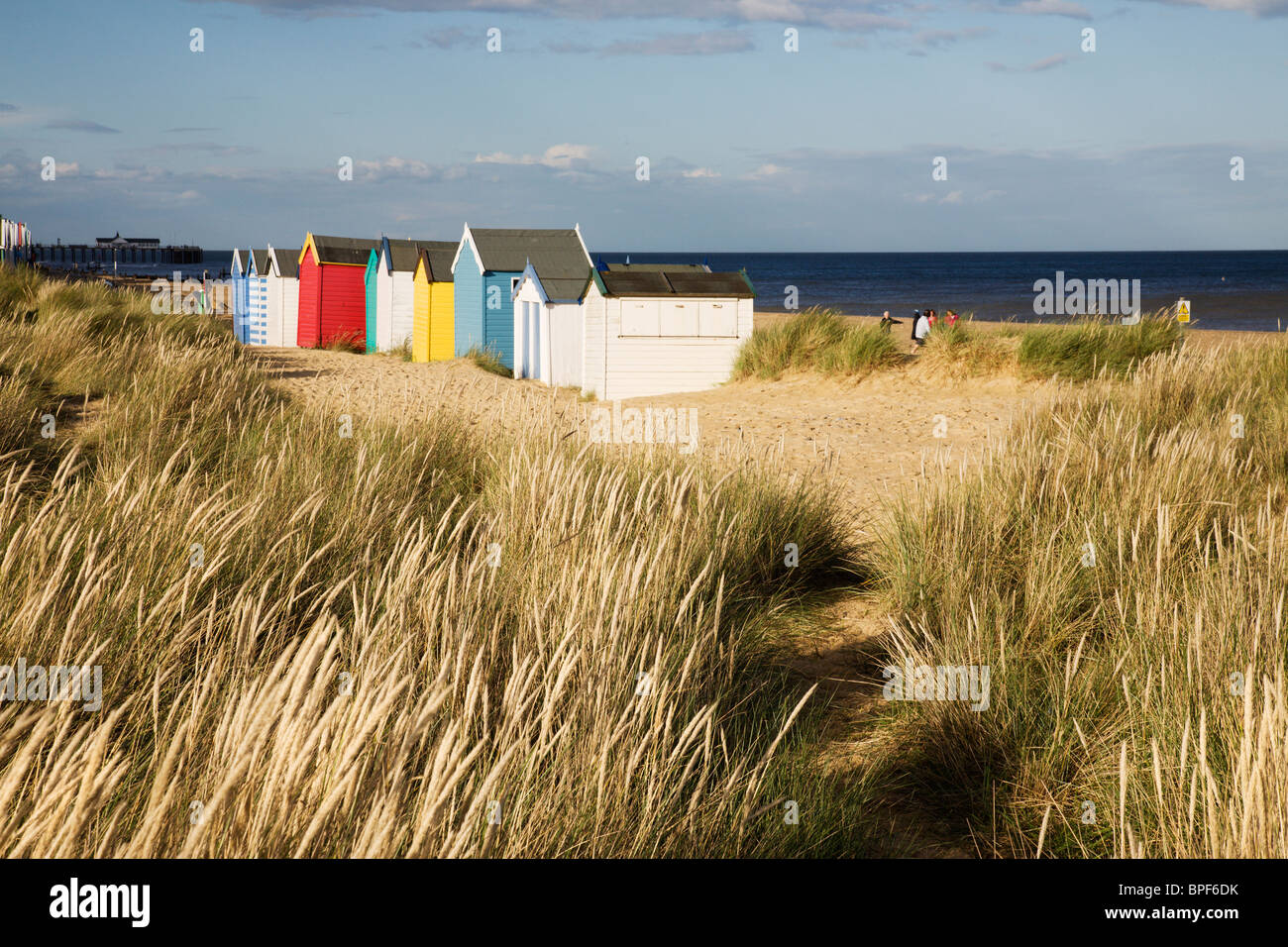 Beach Huts, bathed in a pool of sunlight at Southwold, Suffolk, England. Stock Photo