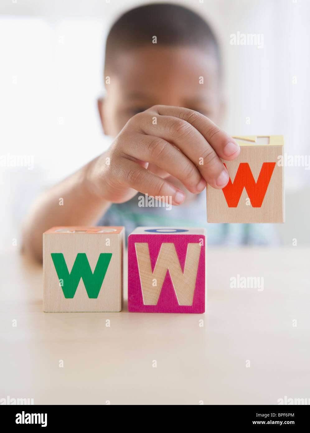 African American boy spelling WWW with blocks Stock Photo