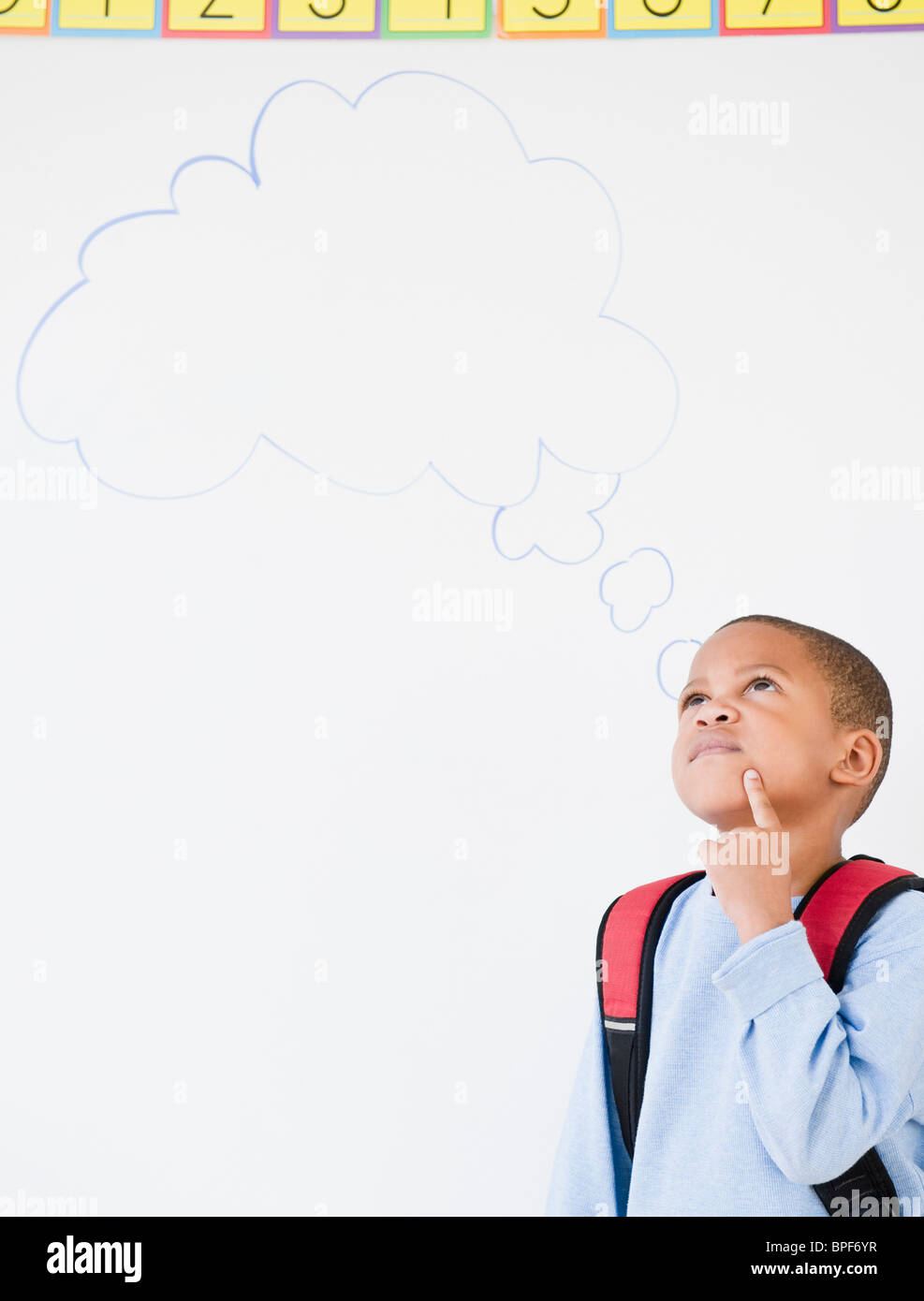 African American boy in school with thought bubble Stock Photo