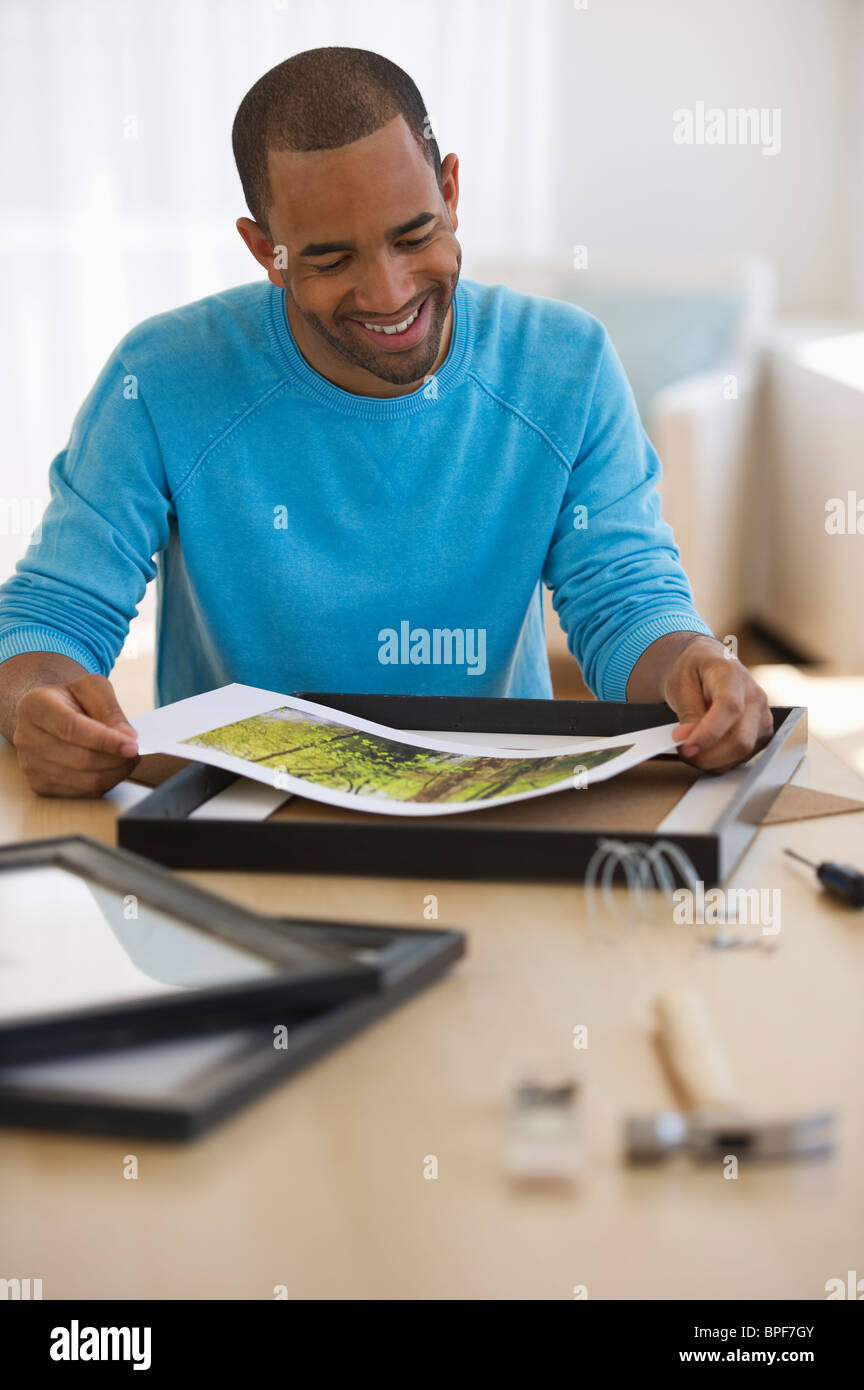 Mixed race man framing picture Stock Photo