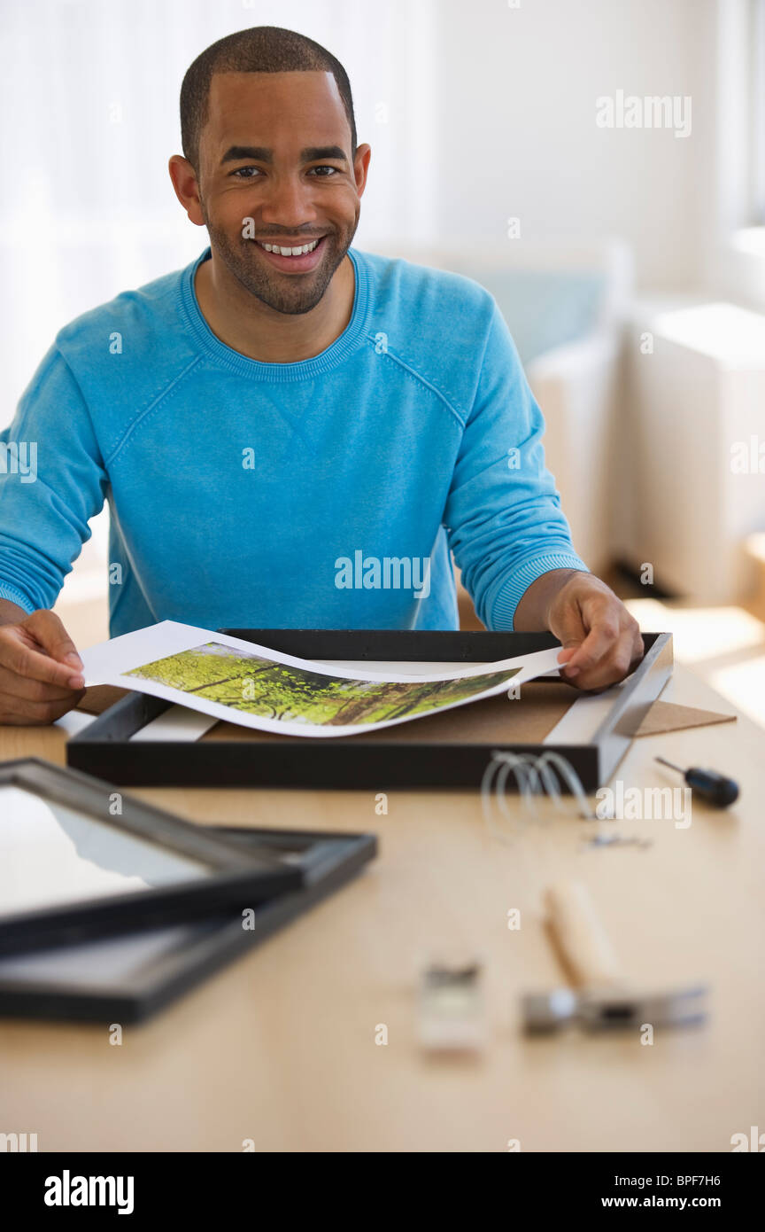 Mixed race man framing picture Stock Photo