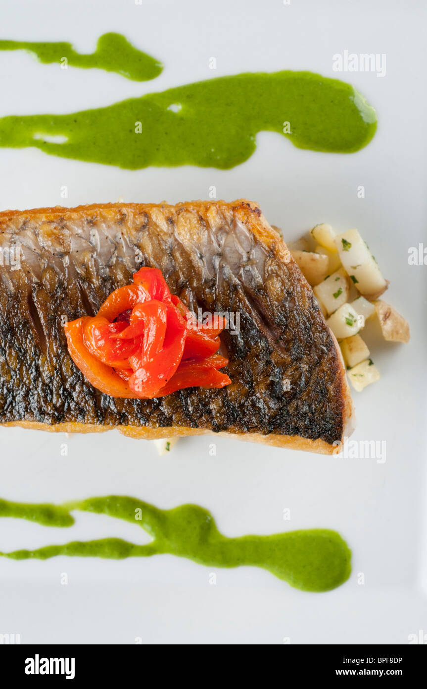 Mullet served on organic vegetables and watercress sauce Stock Photo