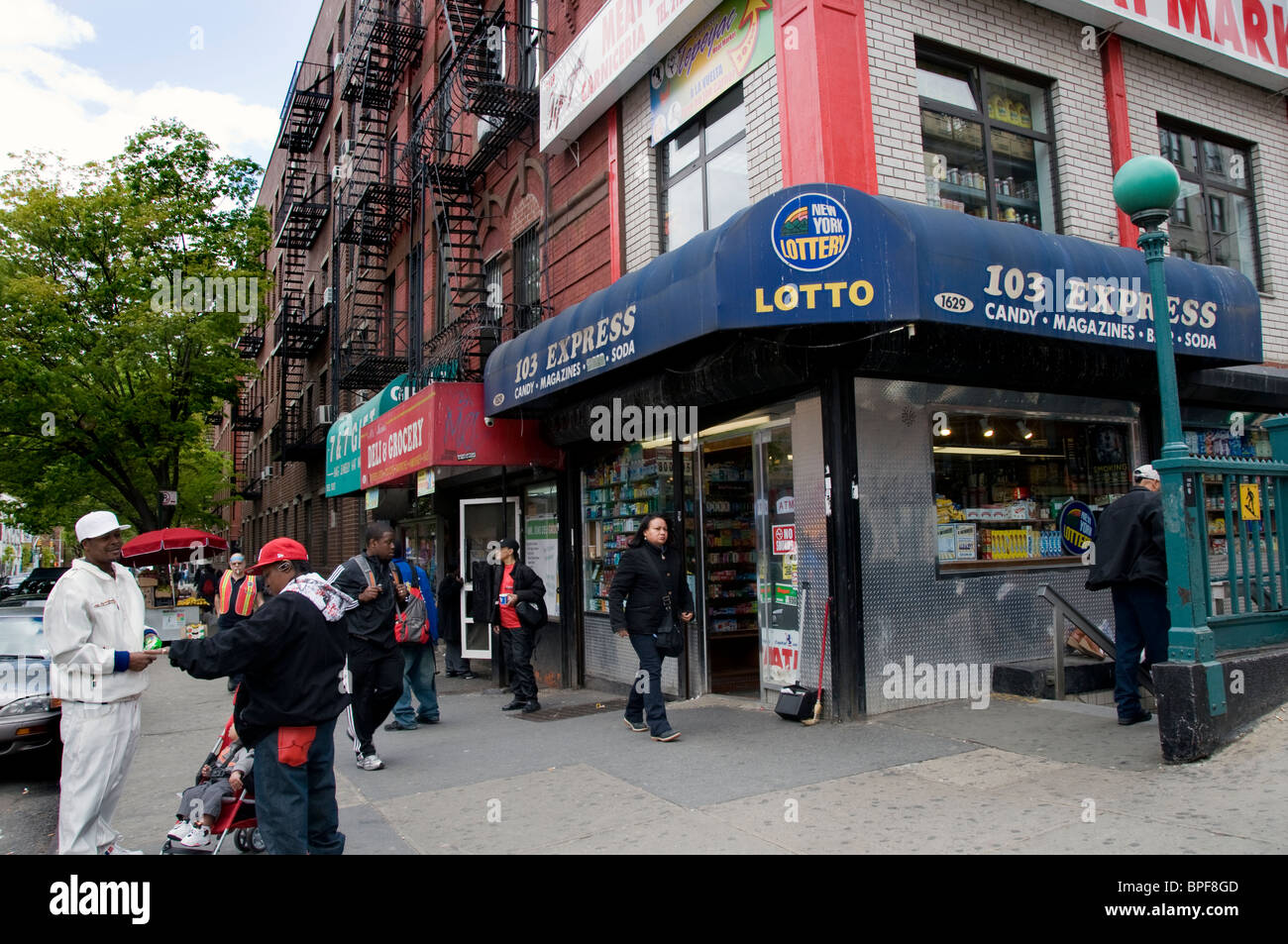East Harlem street corner with local people of the community Stock Photo Alamy