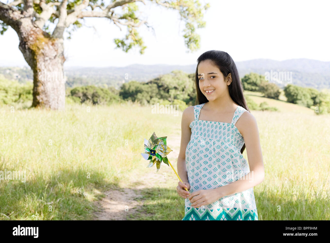 Hispanic girl holding pinwheel in field Stock Photo - Alamy