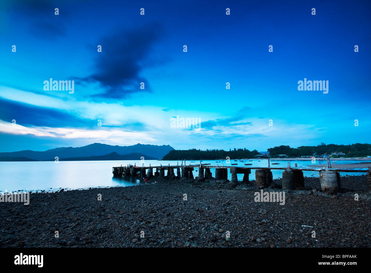 Pier and the sea at sunrise Stock Photo - Alamy