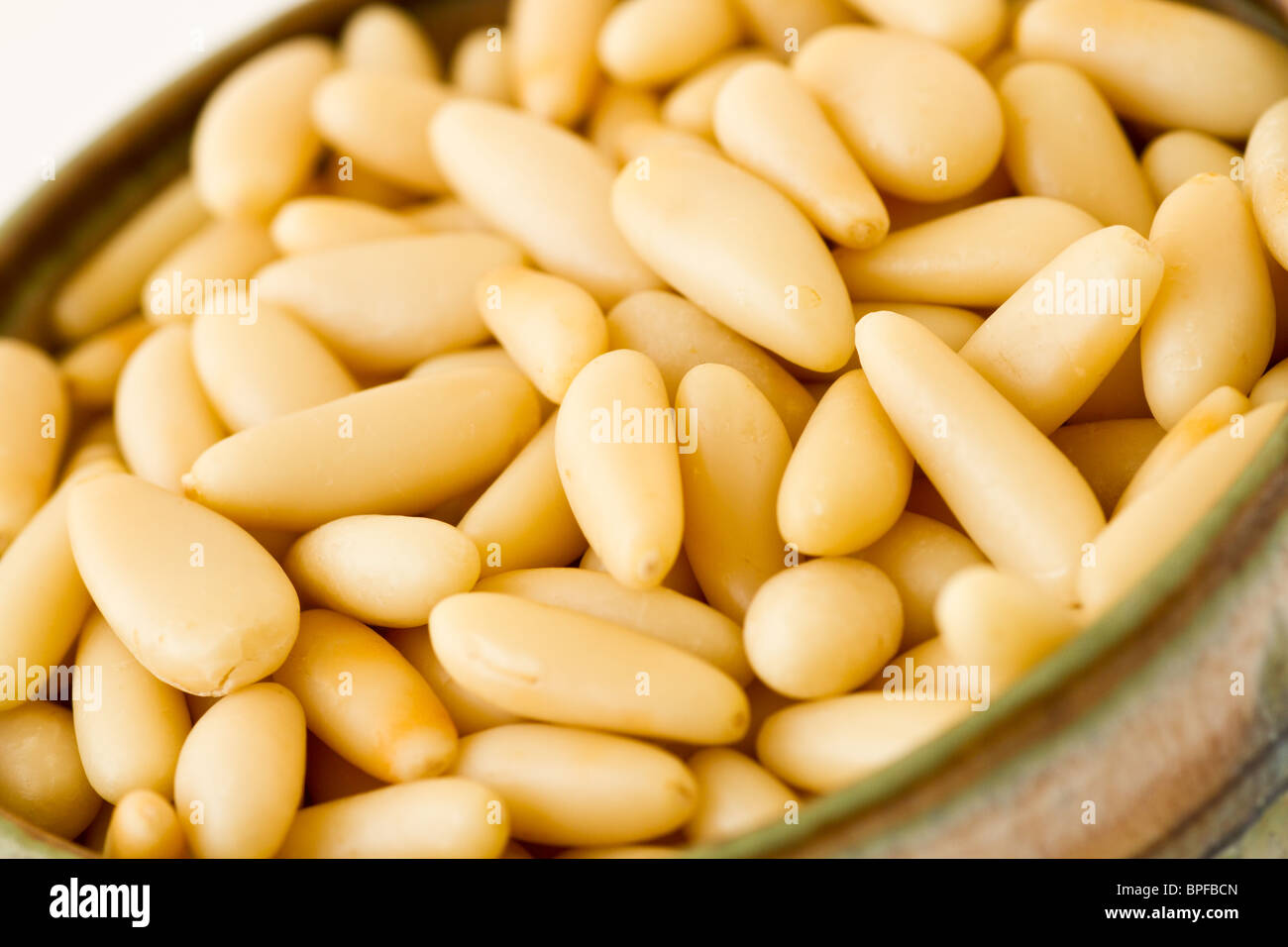 Pine nuts in bowl Stock Photo
