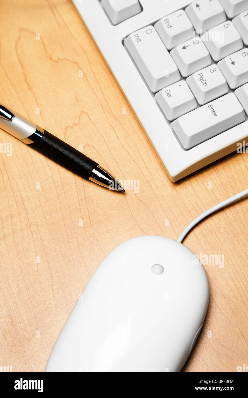 Computer mouse, pen, and computer keyboard Stock Photo