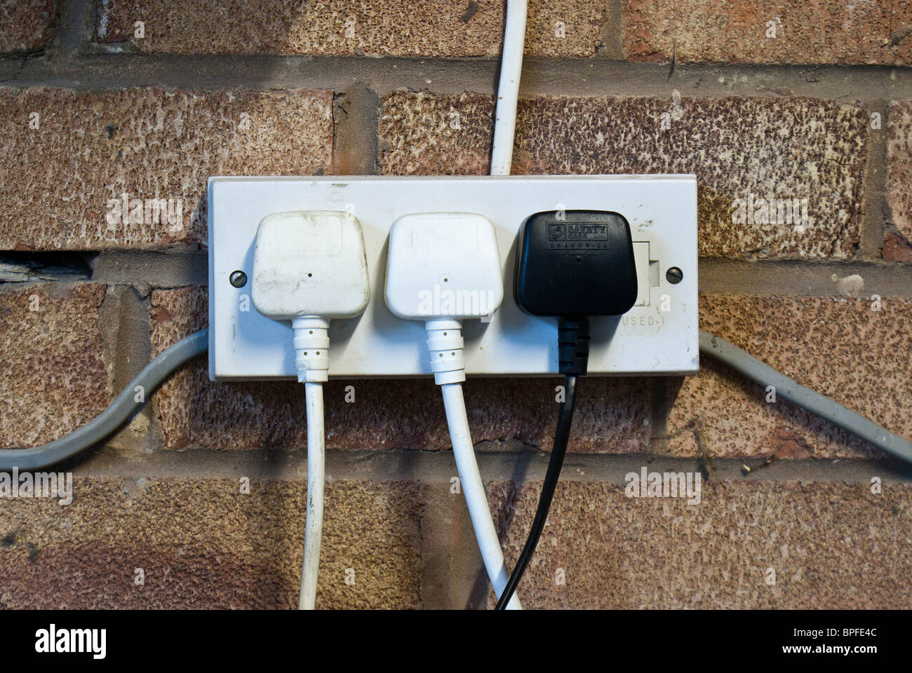 Electrical Plug sockets on a brick wall Stock Photo Alamy