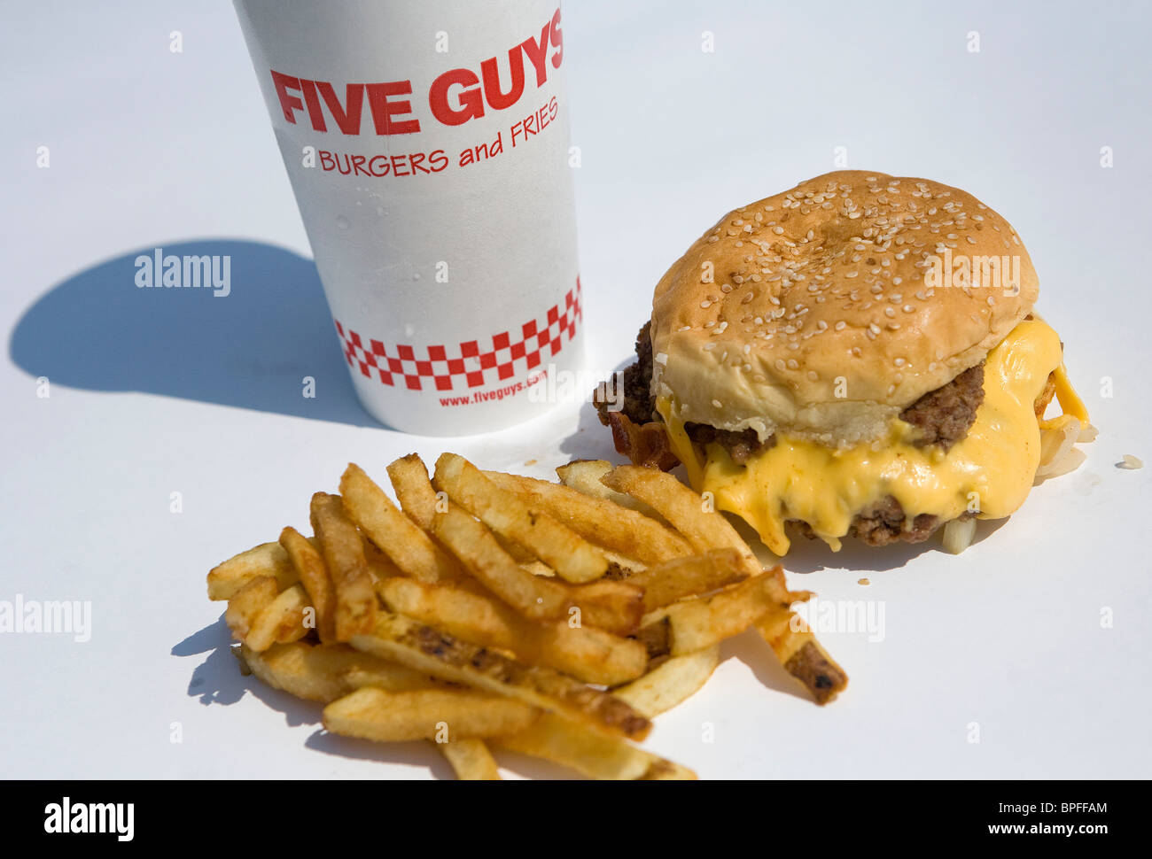 A Five Guys bacon cheeseburger and french fries. Stock Photo