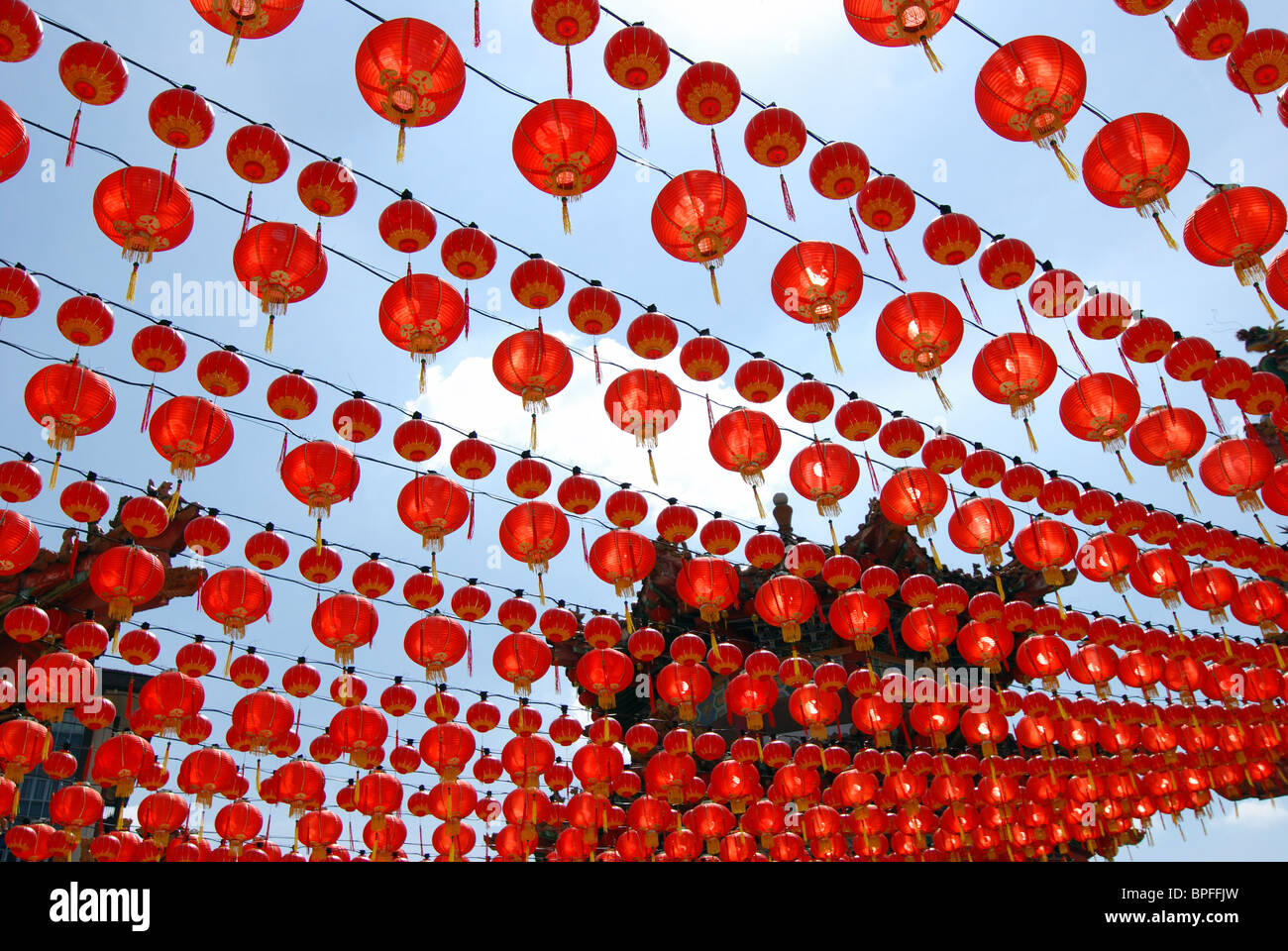 Many red Chinese lanterns hanging in rows above Stock Photo - Alamy