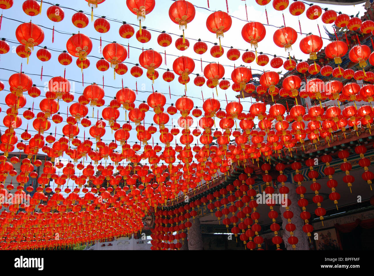 Many red Chinese lanterns hanging in rows above Stock Photo - Alamy