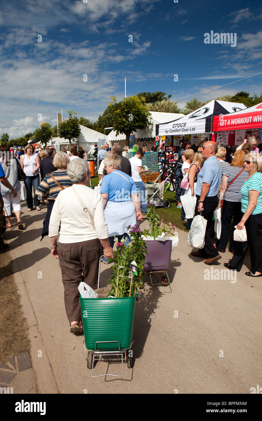 UK, England, Merseyside, Southport Flower Show, visitors carrying bought plants in wheeled shopping baskets Stock Photo