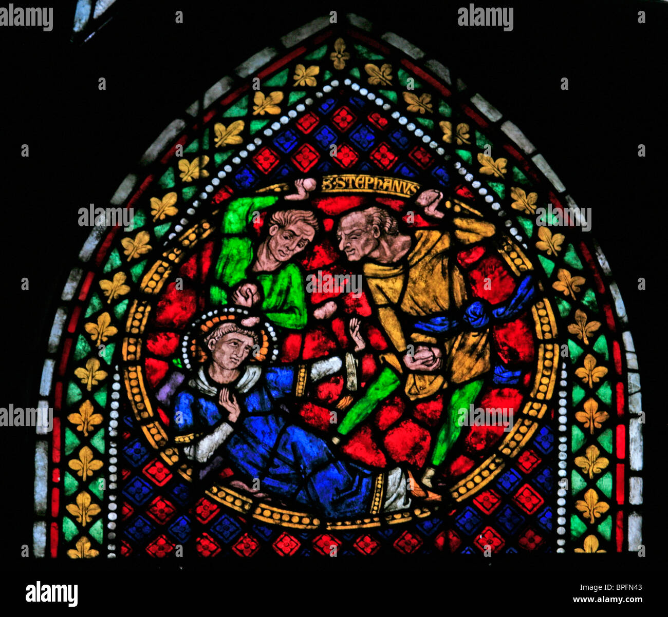 A stained glass window depicting the Martyrdom of Saint Stephen by Stoning to Death, Freiburg Münster, Baden Wurtemburg, Germany Stock Photo