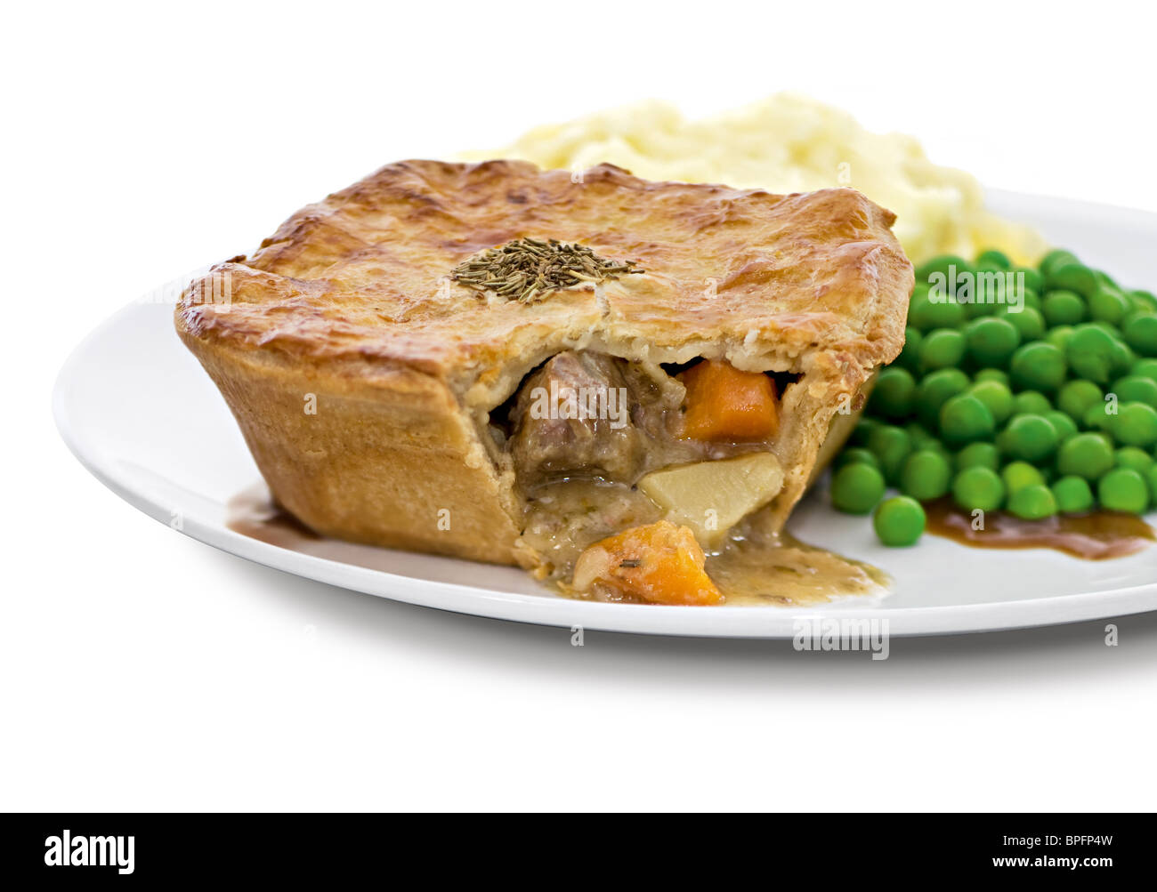 Steak pie with mashed potato and peas. Stock Photo