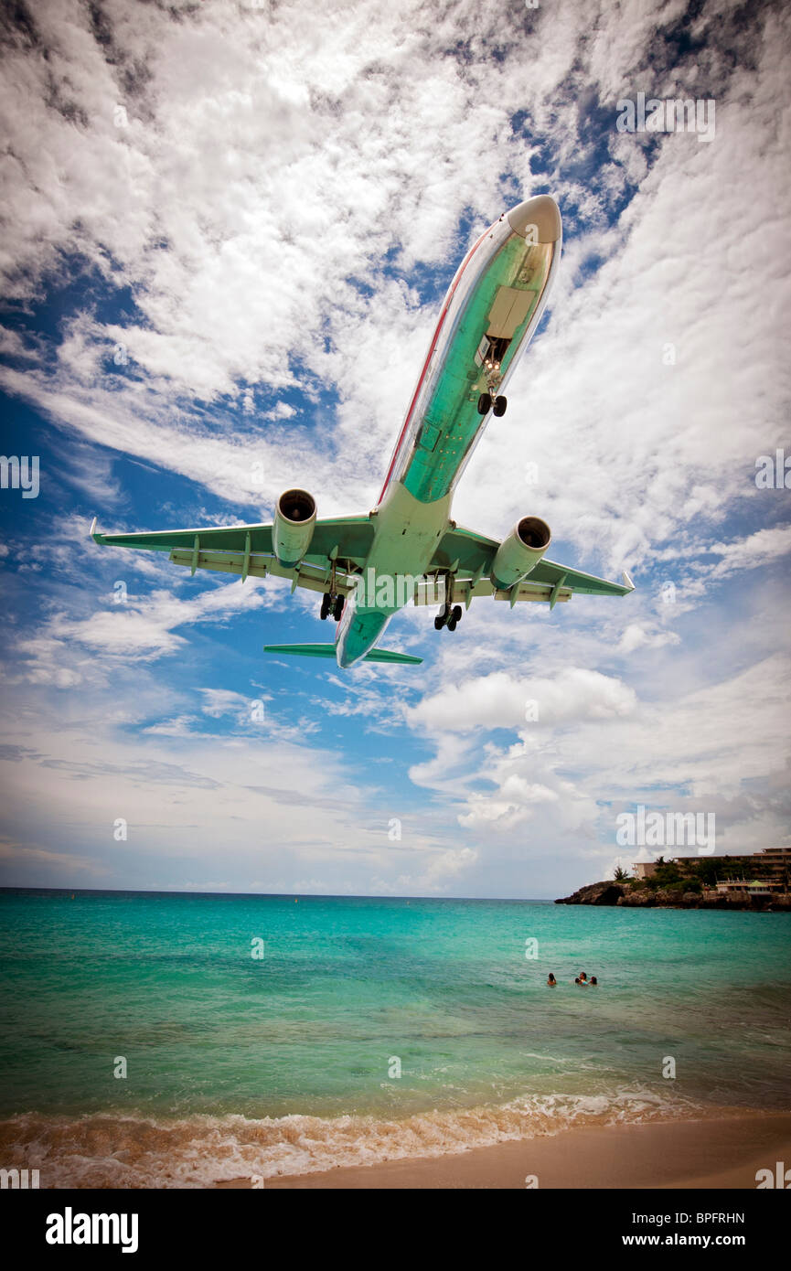 Airplane landing over the beach at Juliana Airport in Saint Martin (St. Maarten). Stock Photo