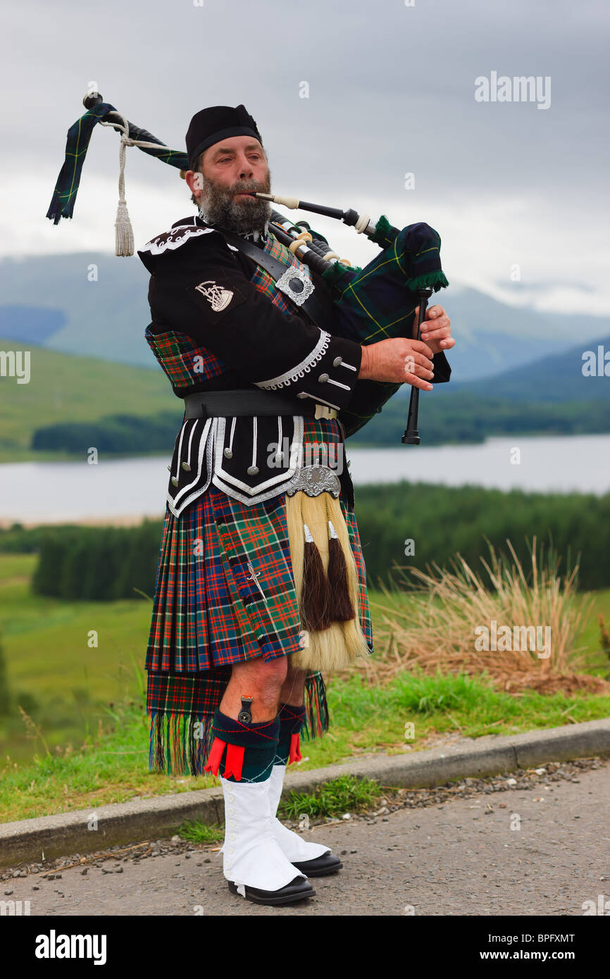 Bagpipe player on the Scottish Highlands Stock Photo
