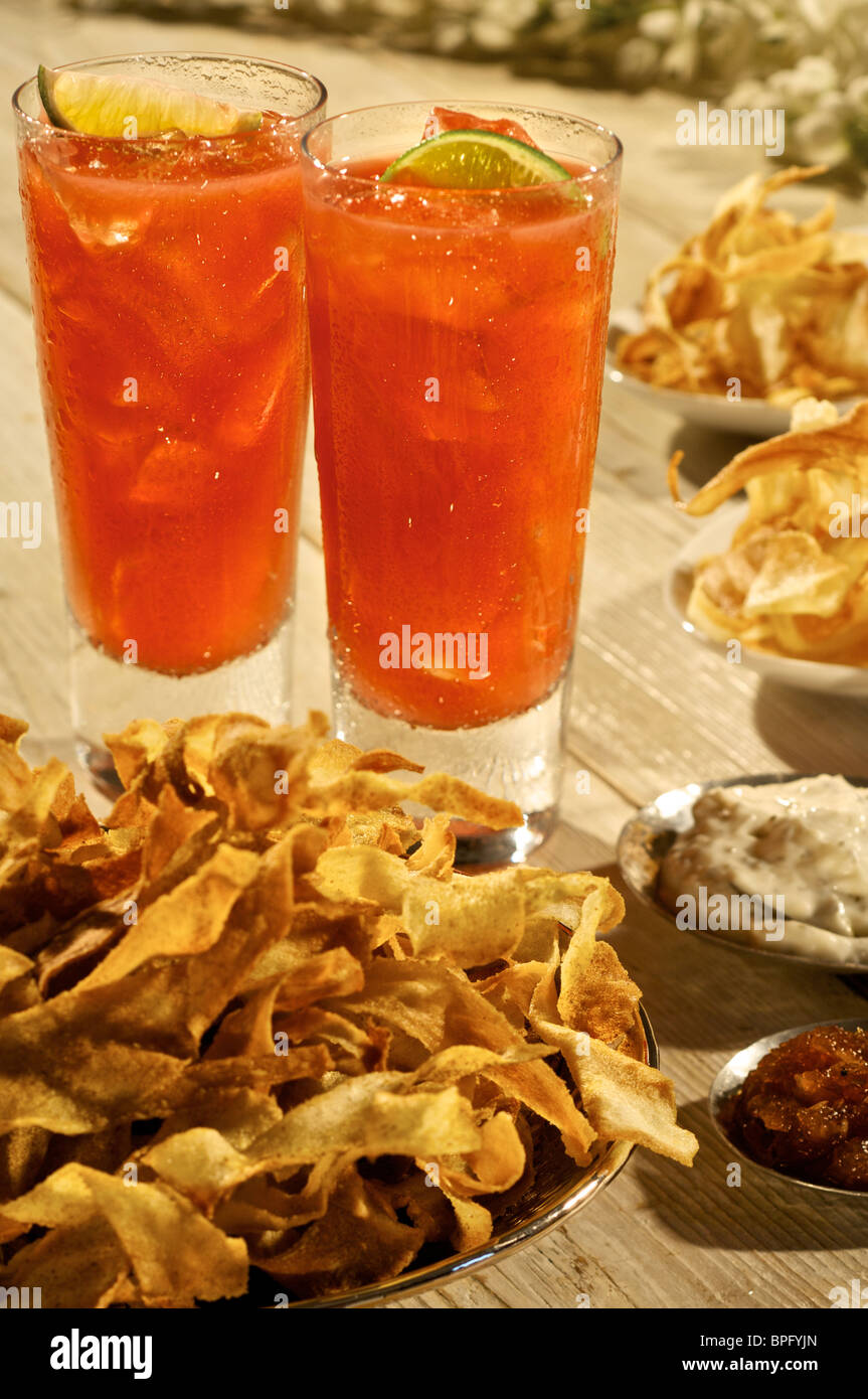Gin and orange drink with party nibbles Stock Photo Alamy