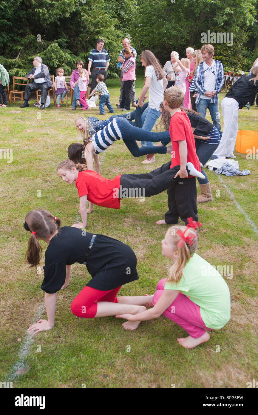 Children compete in the wheelbarrow race at a village fete in Weston