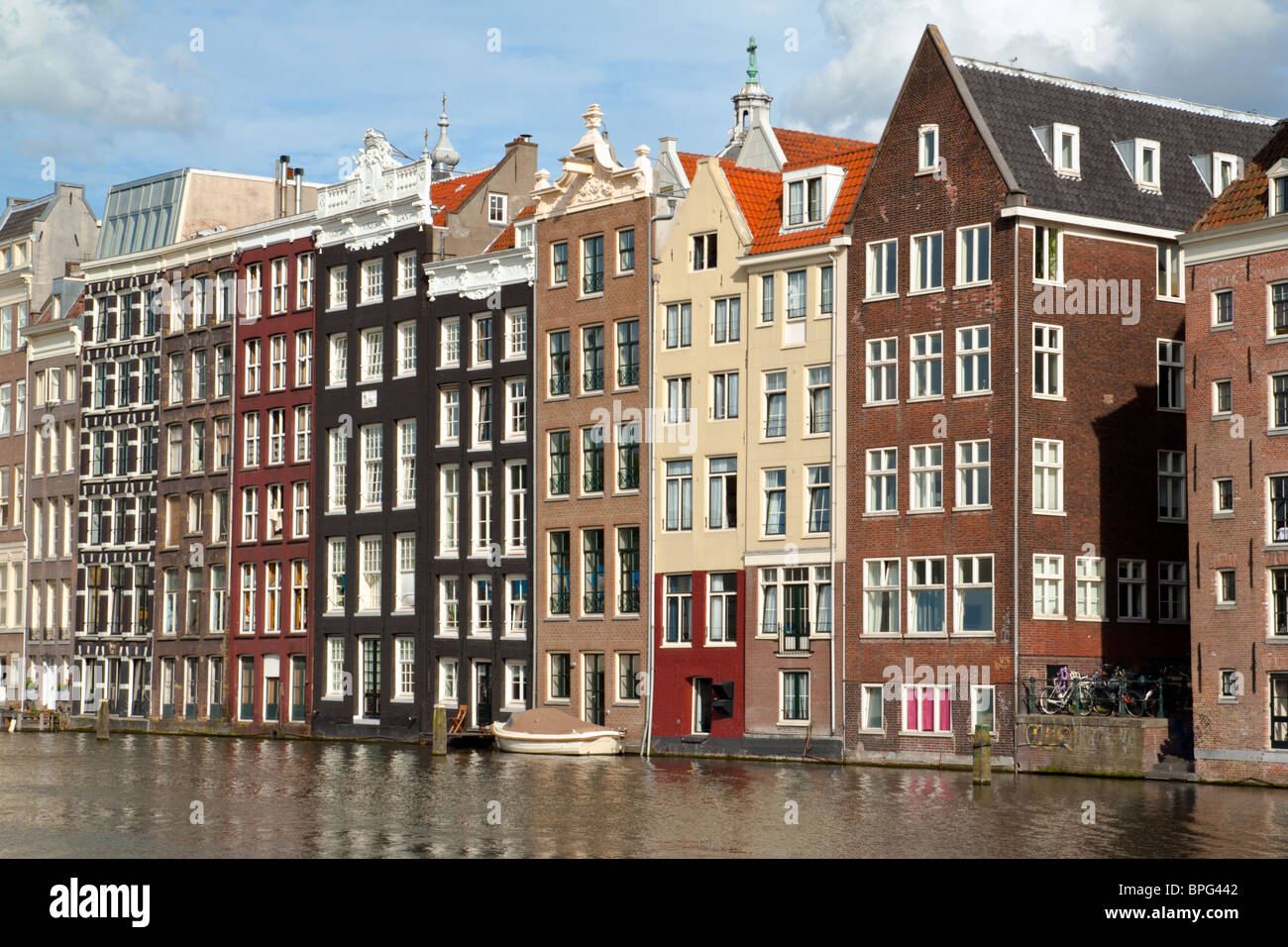Old 17th and 18th century brick houses along a canal in Amsterdam, Holland. Stock Photo