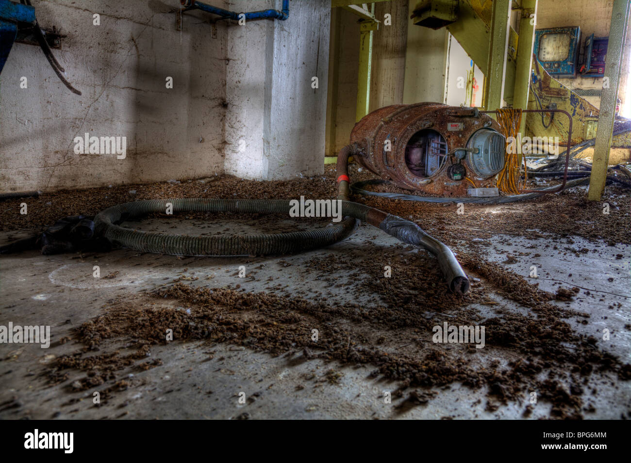 Old industrial hoover, in malt kiln derelict, abm in Louth. Rusty and unloved scrap. Died on the job Stock Photo