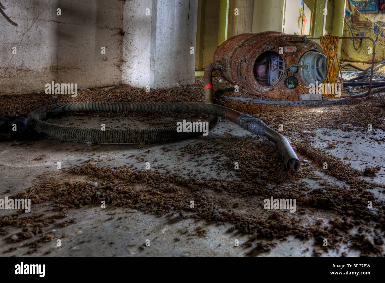 Old industrial hoover, in malt kiln derelict, abm in Louth. Rusty and unloved scrap. Died on the job Stock Photo