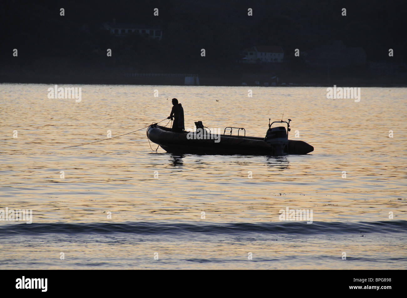 Motor dingy at sunset, Jersey Stock Photo