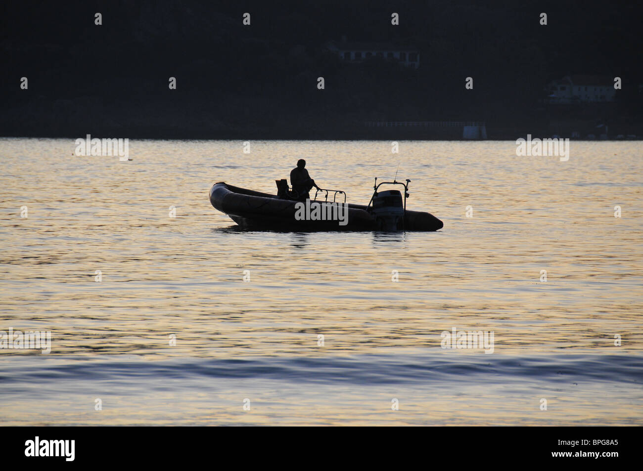 Motor dingy at sunset, Jersey Stock Photo