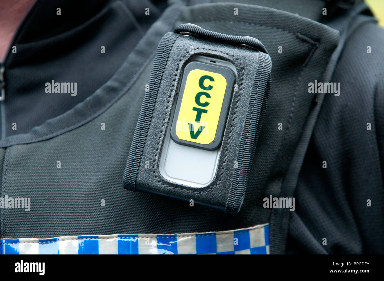 A Strathclyde Police officer using a personal CCTV. The digital cameras are worn on the shoulder and record sound and images. Stock Photo