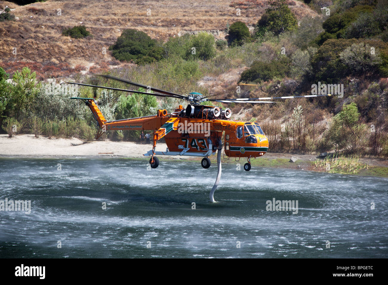 Firefighting helicopter taking on water Stock Photo Alamy