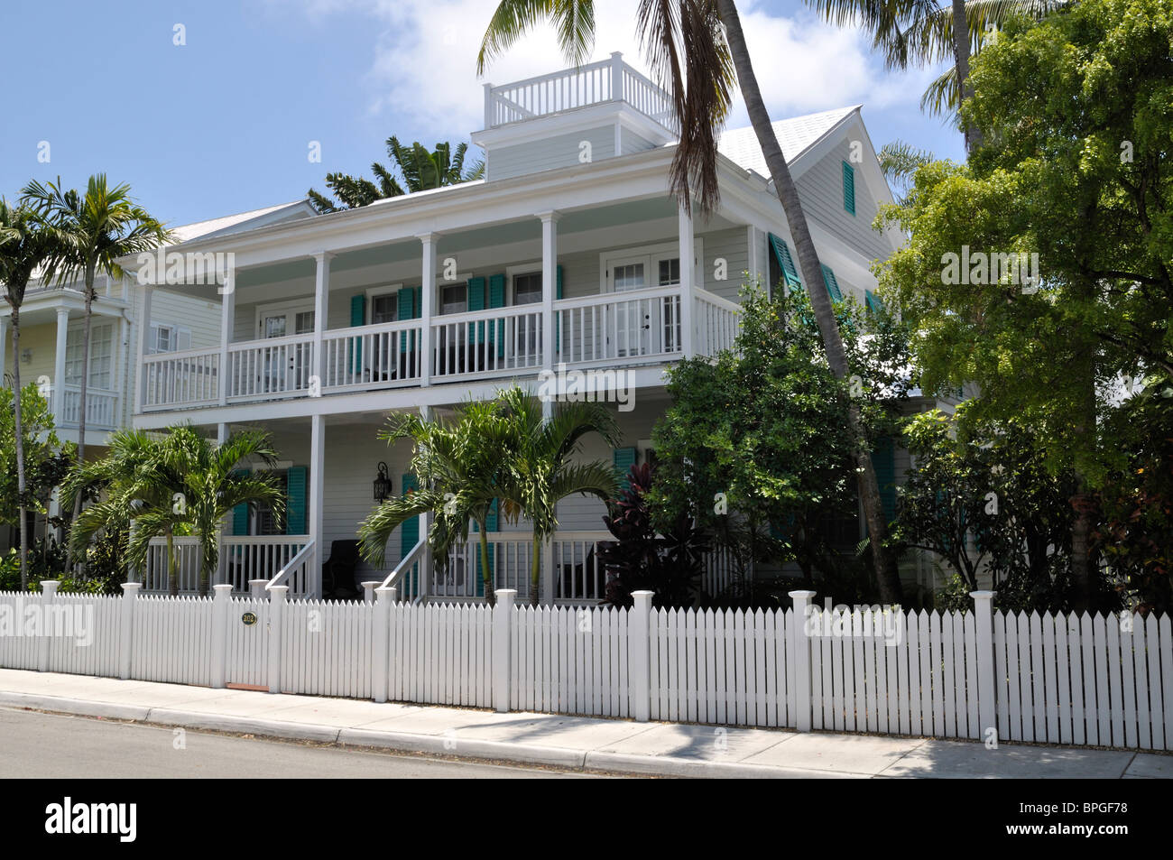 Key west home and picket fence in tropical yard Stock Photo Alamy