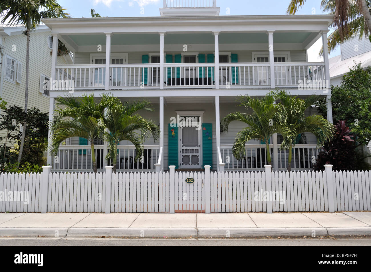 Key west home and picket fence in tropical yard Stock Photo Alamy