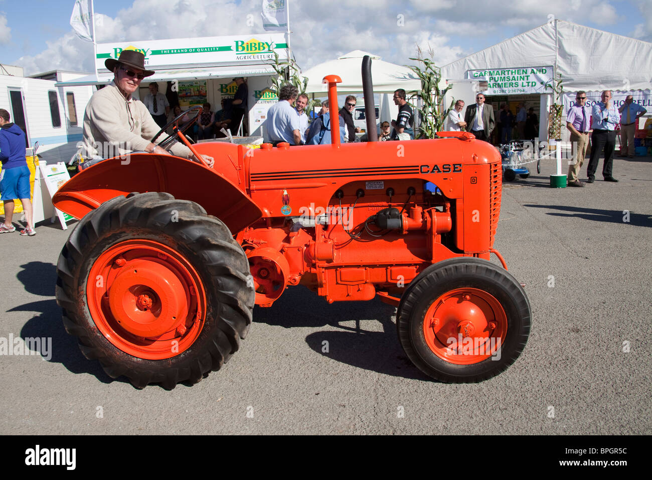 Vintage orange case tractor machinery parade at agricultural