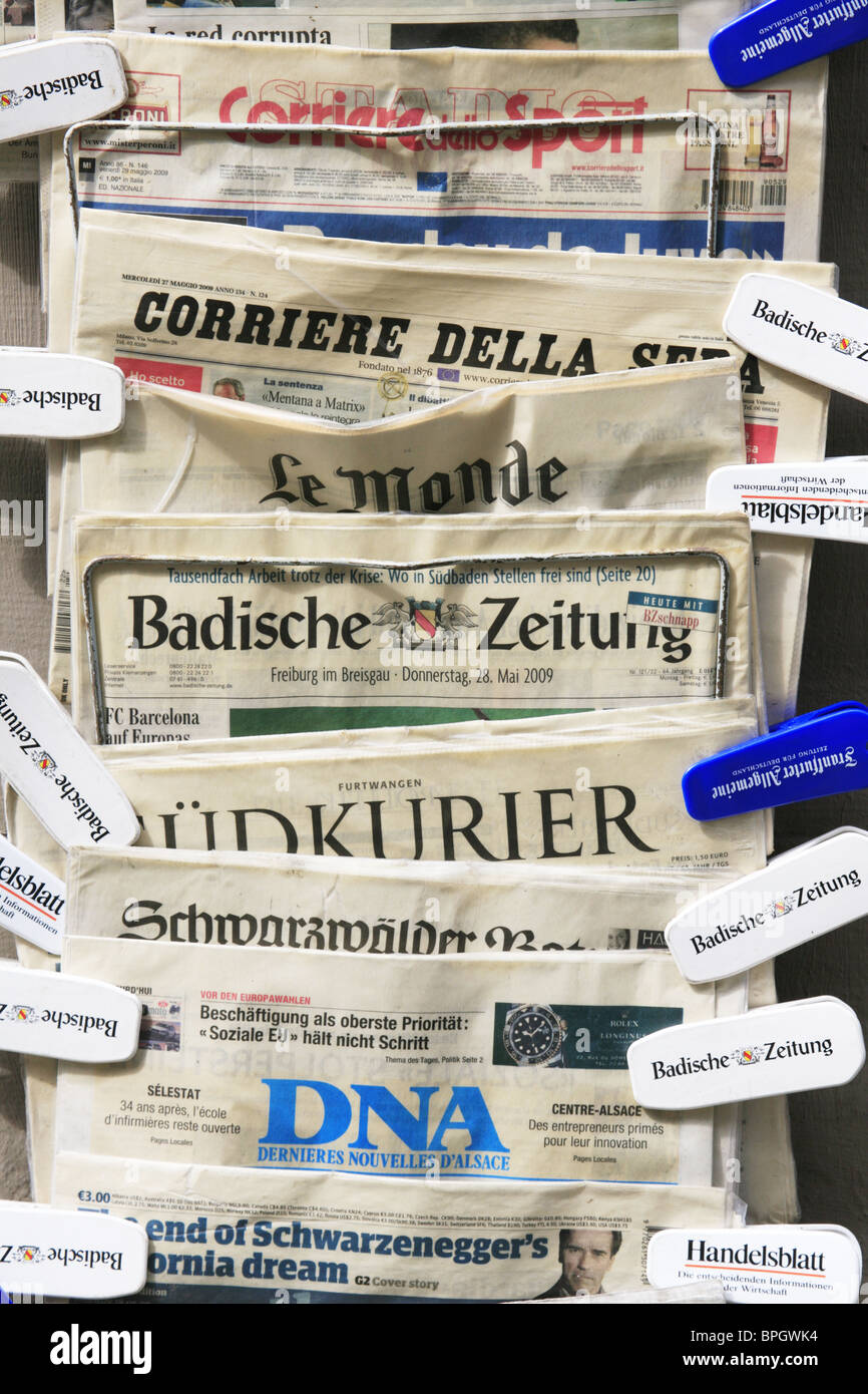 German, Italian and French newspapers on sale outside a paper shop in Freiburg im Breisgau, Germany Stock Photo