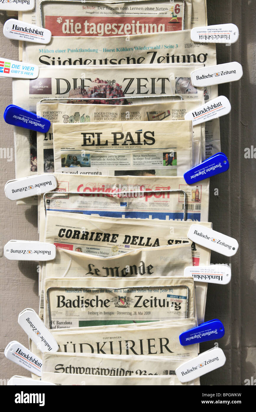 German, French, Italian and Spanish newspapers on sale outside a paper shop in Freiburg im Breisgau, Germany Stock Photo