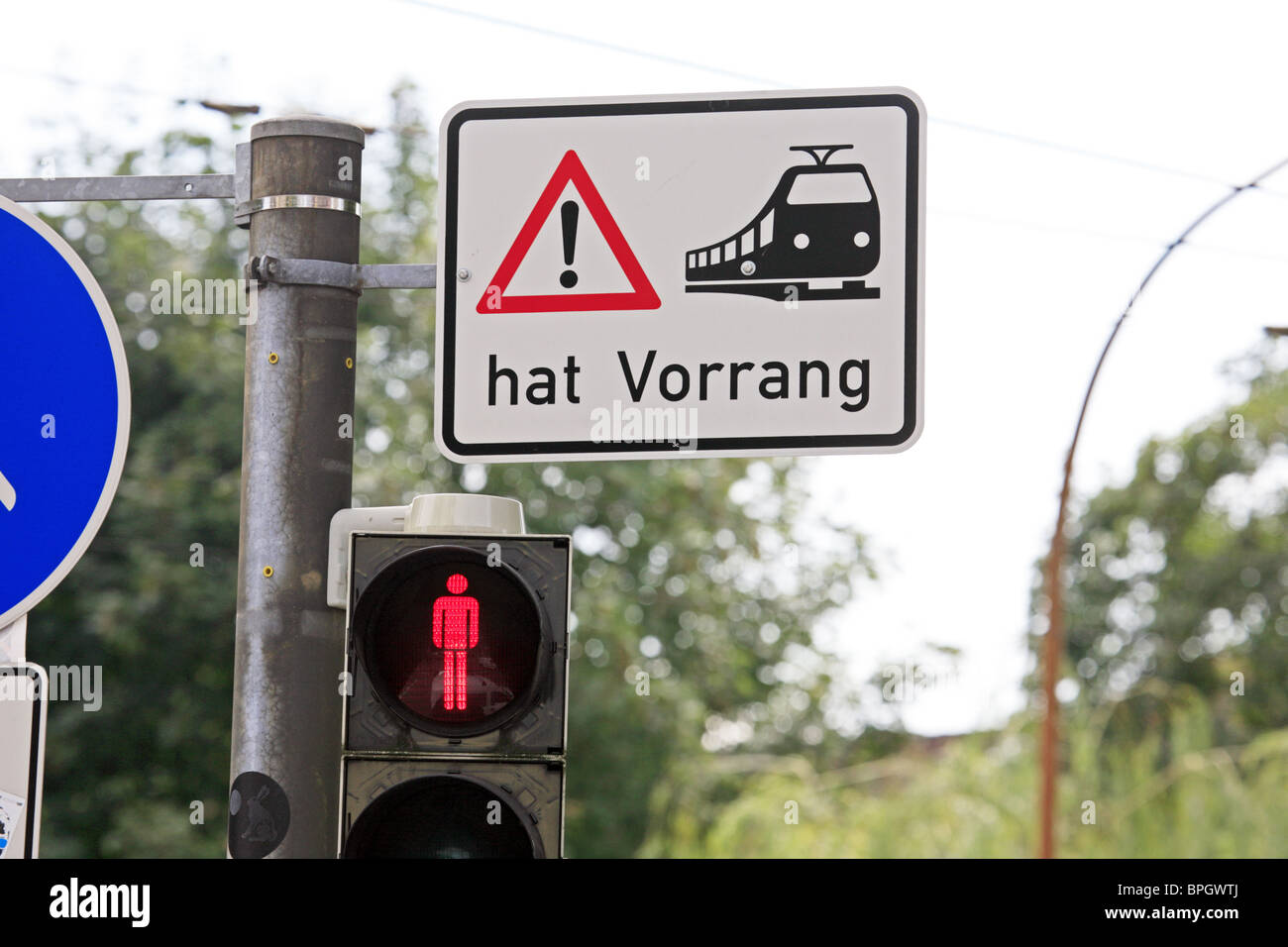 Germany; Sign warning pedestrians at a road crossing that trams have priority Stock Photo