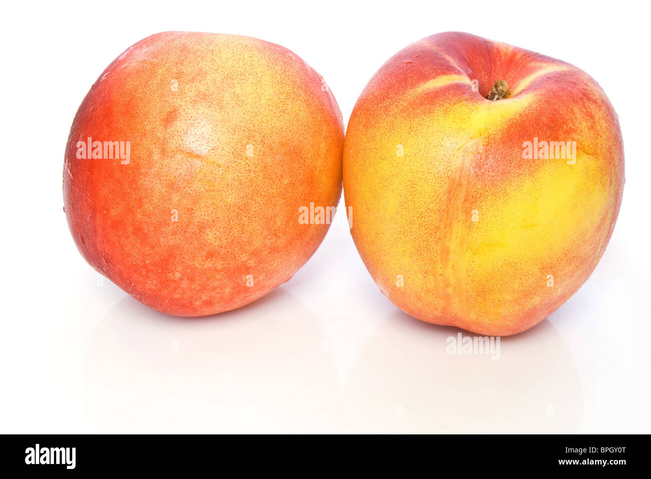 two fresh ripe nectarines isolated on white background Stock Photo Alamy