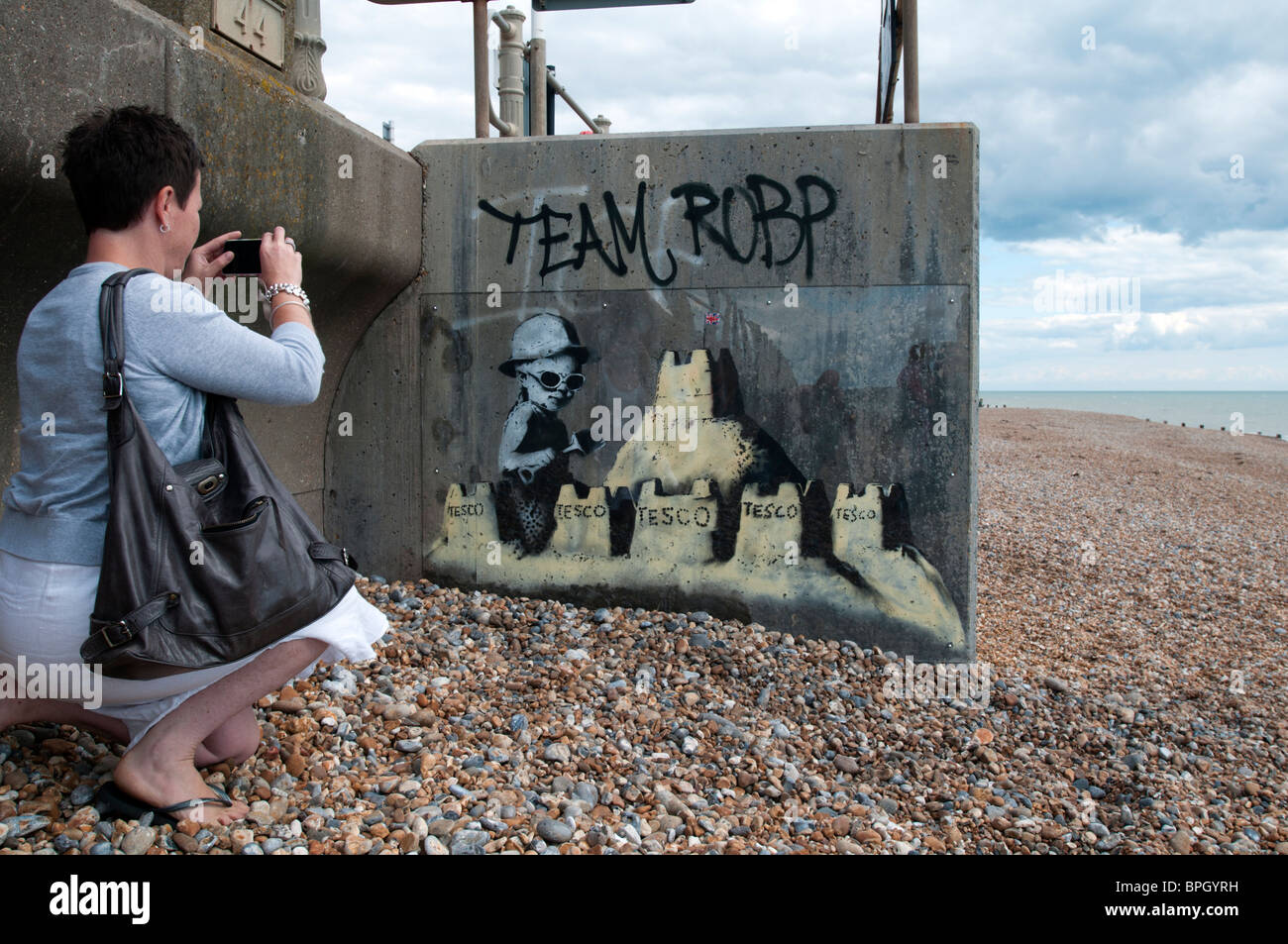 ST. LEONARDS ON SEA, ENGLAND - AUGUST 28: A mural thought to be by Banksy on the seafront attracts attention. Stock Photo